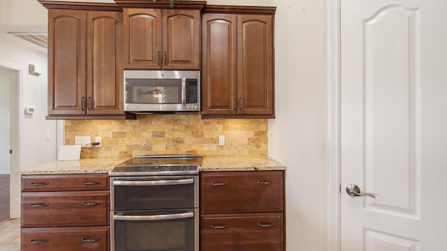 108 Colony Bay Harbour Dr, Panama City Beach, FL 32407 - kitchen with stainless steel appliances, tasteful backsplash, and light stone counters
