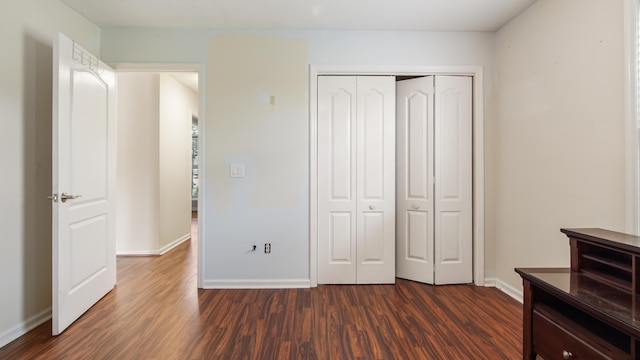 108 Colony Bay Harbour Dr, Panama City Beach, FL 32407 - unfurnished bedroom with dark wood-type flooring, baseboards, and a closet