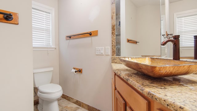 108 Colony Bay Harbour Dr, Panama City Beach, FL 32407 - bathroom featuring vanity, toilet, baseboards, and plenty of natural light