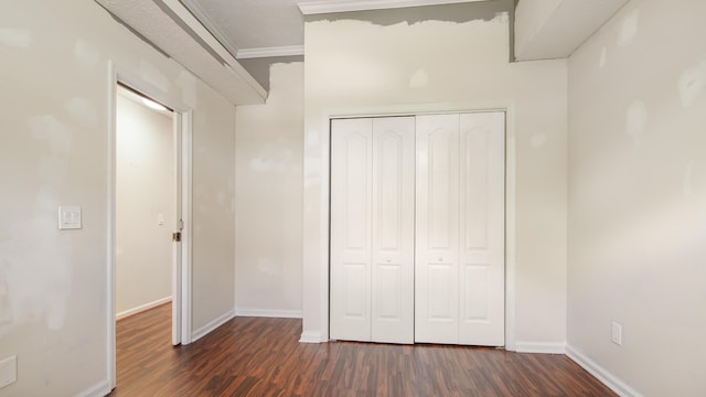 108 Colony Bay Harbour Dr, Panama City Beach, FL 32407 - unfurnished bedroom with dark wood-type flooring, crown molding, baseboards, and a closet