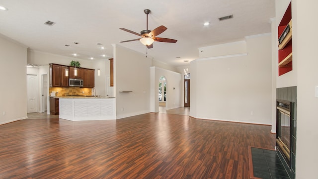 108 Colony Bay Harbour Dr, Panama City Beach, FL 32407 - unfurnished living room featuring a tile fireplace, ceiling fan, recessed lighting, dark wood-style flooring, and baseboards