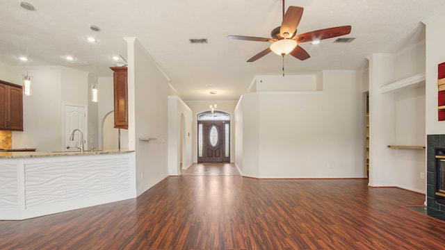 108 Colony Bay Harbour Dr, Panama City Beach, FL 32407 - unfurnished living room with dark wood-style floors, ceiling fan, a sink, crown molding, and arched walkways