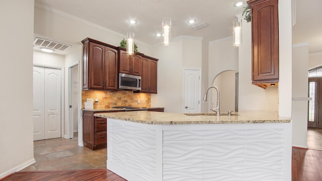 108 Colony Bay Harbour Dr, Panama City Beach, FL 32407 - kitchen with appliances with stainless steel finishes, a sink, ornamental molding, light stone countertops, and backsplash