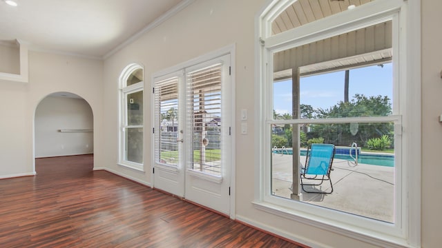 108 Colony Bay Harbour Dr, Panama City Beach, FL 32407 - doorway featuring wood finished floors, arched walkways, crown molding, and baseboards