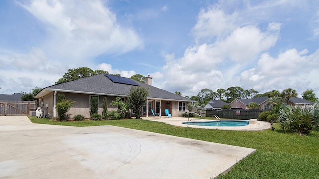 108 Colony Bay Harbour Dr, Panama City Beach, FL 32407 - back of house featuring solar panels, a patio area, and a chimney