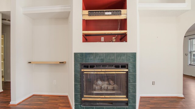 108 Colony Bay Harbour Dr, Panama City Beach, FL 32407 - detailed view of wood finished floors, a tile fireplace, arched walkways, and baseboards