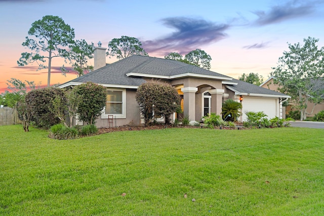108 Colony Bay Harbour Dr, Panama City Beach, FL 32407 - view of front facade featuring a chimney, an attached garage, asphalt driveway, and a lawn