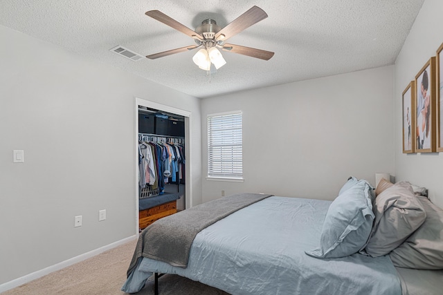 617 Schneider Dr, Fort Walton Beach, FL 32547 - carpeted bedroom with a textured ceiling, a closet, baseboards, and a ceiling fan