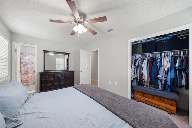 617 Schneider Dr, Fort Walton Beach, FL 32547 - bedroom with multiple windows, a closet, a textured ceiling, ceiling fan, and carpet flooring