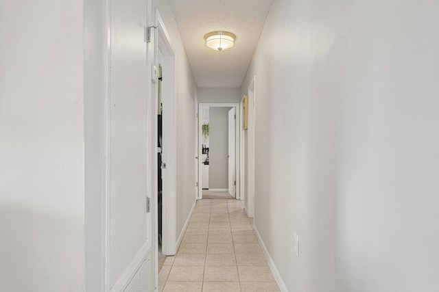 617 Schneider Dr, Fort Walton Beach, FL 32547 - corridor with light tile patterned floors, a textured ceiling, and baseboards