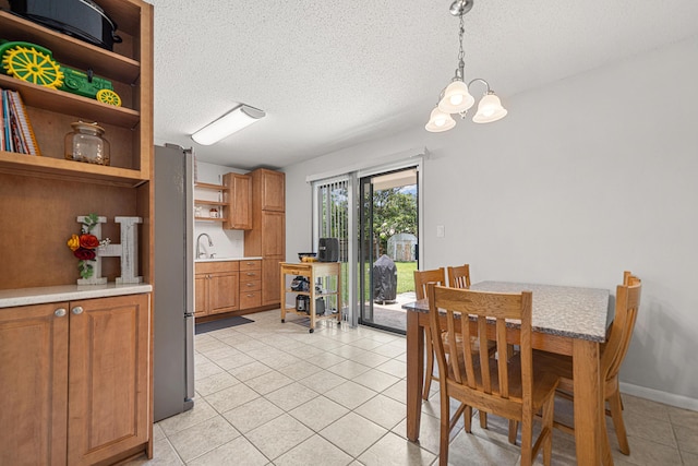 617 Schneider Dr, Fort Walton Beach, FL 32547 - dining space with light tile patterned flooring, a textured ceiling, and a chandelier