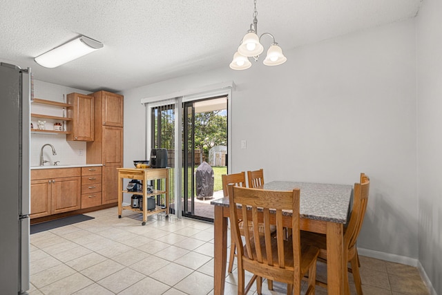 617 Schneider Dr, Fort Walton Beach, FL 32547 - dining area with light tile patterned flooring, a chandelier, and a textured ceiling