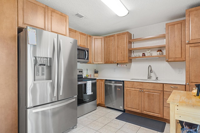 617 Schneider Dr, Fort Walton Beach, FL 32547 - kitchen with stainless steel appliances, a sink, light countertops, light tile patterned flooring, and open shelves