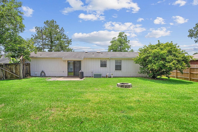 617 Schneider Dr, Fort Walton Beach, FL 32547 - back of property featuring a fire pit, central AC unit, a patio, and roof with shingles