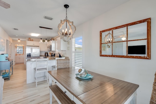 8436 Gulf Blvd Unit 734, Navarre, FL 32566 - dining space with a chandelier and light wood-type flooring