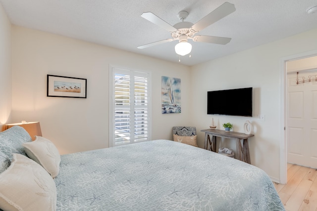 8436 Gulf Blvd Unit 734, Navarre, FL 32566 - bedroom with light wood-style floors, a ceiling fan, and baseboards