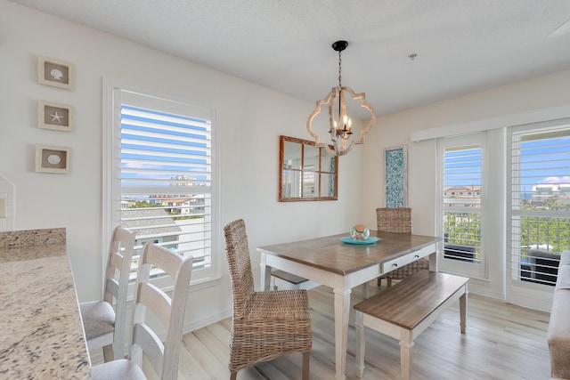 8436 Gulf Blvd Unit 734, Navarre, FL 32566 - dining area featuring a chandelier, light wood-type flooring, and plenty of natural light