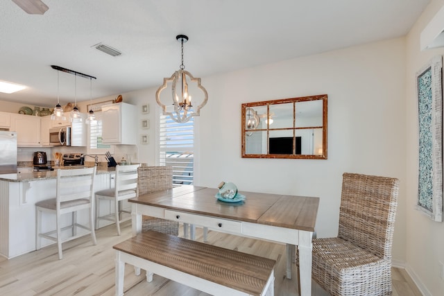 8436 Gulf Blvd Unit 734, Navarre, FL 32566 - dining area featuring a chandelier and light wood-style floors