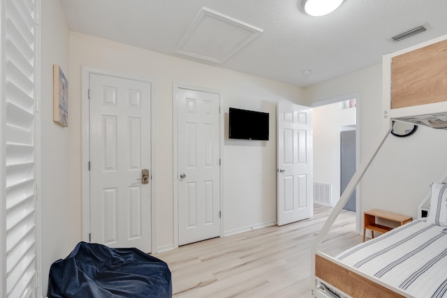 8436 Gulf Blvd Unit 734, Navarre, FL 32566 - bedroom with light wood finished floors, attic access, and baseboards
