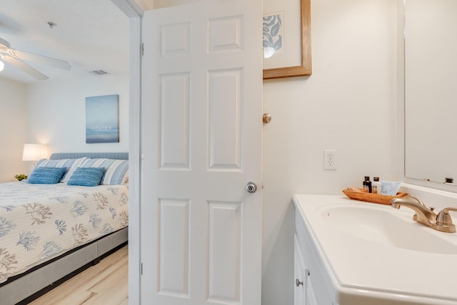 8436 Gulf Blvd Unit 734, Navarre, FL 32566 - ensuite bathroom featuring vanity, a ceiling fan, and wood finished floors