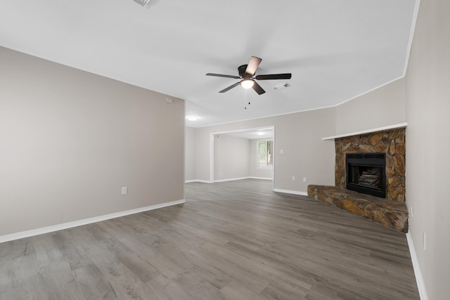 3437 Auburn Rd, Crestview, FL 32539 - unfurnished living room with baseboards, a ceiling fan, wood finished floors, and a fireplace