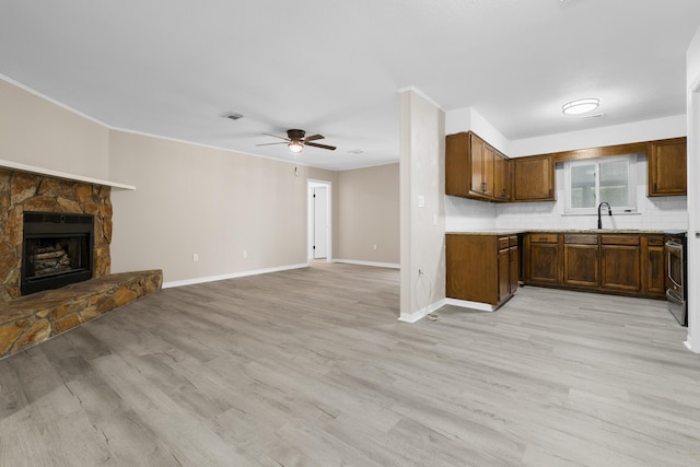 3437 Auburn Rd, Crestview, FL 32539 - kitchen with ceiling fan, open floor plan, a sink, baseboards, and range