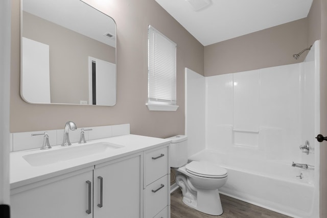3437 Auburn Rd, Crestview, FL 32539 - full bathroom featuring wood finished floors, vanity, toilet, and tub / shower combination