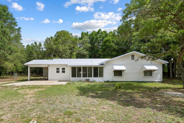 3437 Auburn Rd, Crestview, FL 32539 - rear view of house featuring an attached carport, a yard, driveway, and a metal roof