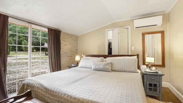 2765 Shade Tree Ln, Ponce De Leon, FL 32455 - bedroom featuring a wall mounted air conditioner, vaulted ceiling, and wood finished floors