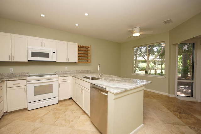 115 Gleneagles Dr, Niceville, FL 32578 - kitchen with white appliances, a sink, a peninsula, white cabinetry, and recessed lighting