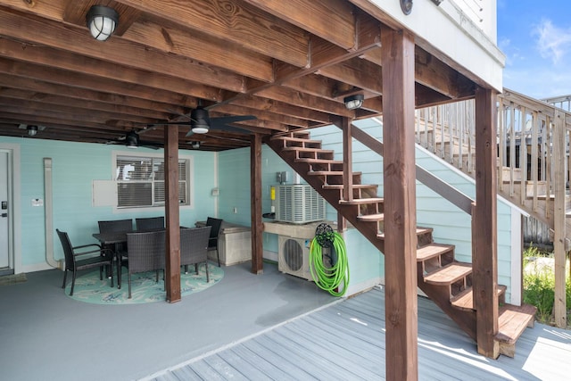 415 Gulf Shore Dr Unit 23, Destin, FL 32541 - wooden deck with stairs, a ceiling fan, and outdoor dining area