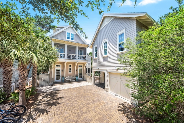21 Founders Ct, Watersound, FL 32461 - view of front facade featuring a garage, driveway, and a balcony