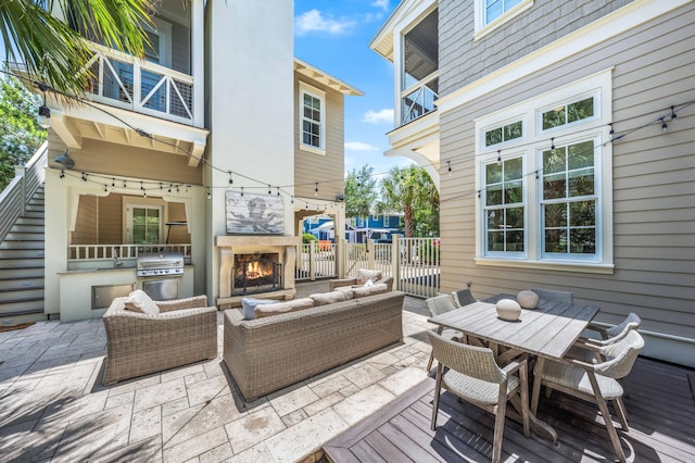 21 Founders Ct, Watersound, FL 32461 - patio / terrace featuring an outdoor living space with a fireplace, a patio, area for grilling, and outdoor dining space