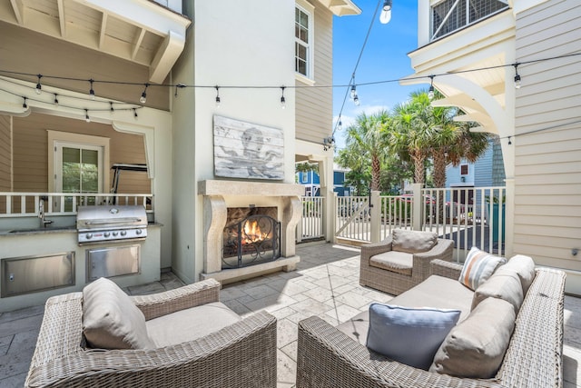 21 Founders Ct, Watersound, FL 32461 - view of patio featuring an outdoor living space with a fireplace and area for grilling