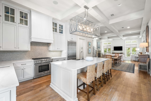 21 Founders Ct, Watersound, FL 32461 - kitchen with high end appliances, coffered ceiling, open floor plan, a chandelier, and beamed ceiling