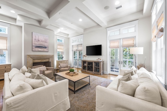 21 Founders Ct, Watersound, FL 32461 - living area featuring a fireplace, wood finished floors, beam ceiling, healthy amount of natural light, and coffered ceiling