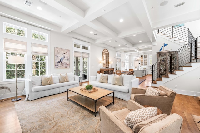 21 Founders Ct, Watersound, FL 32461 - living area featuring light wood-type flooring, stairs, coffered ceiling, beam ceiling, and french doors