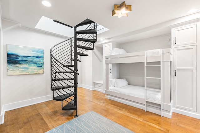 21 Founders Ct, Watersound, FL 32461 - bedroom with a skylight, light wood-style floors, and recessed lighting