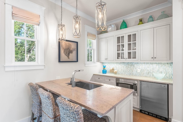 21 Founders Ct, Watersound, FL 32461 - kitchen featuring stainless steel appliances, a breakfast bar area, healthy amount of natural light, and light stone counters