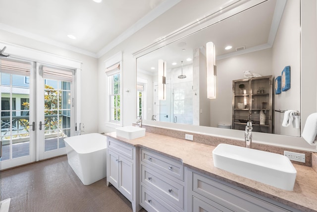 21 Founders Ct, Watersound, FL 32461 - bathroom with ornamental molding, a stall shower, double vanity, a soaking tub, and french doors