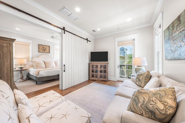 21 Founders Ct, Watersound, FL 32461 - living room with a barn door, wood finished floors, recessed lighting, ornamental molding, and a ceiling fan