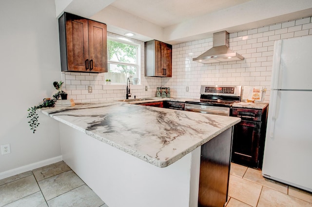 636 Carnathan Ct, Fort Walton Beach, FL 32547 - kitchen featuring freestanding refrigerator, wall chimney range hood, a sink, stainless steel electric range, and a peninsula