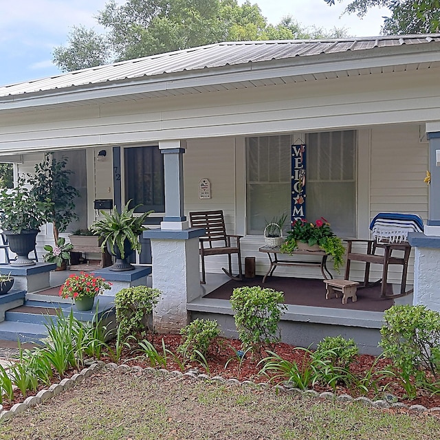 72 Park Ave, Defuniak Springs, FL 32435 - doorway to property featuring covered porch and metal roof