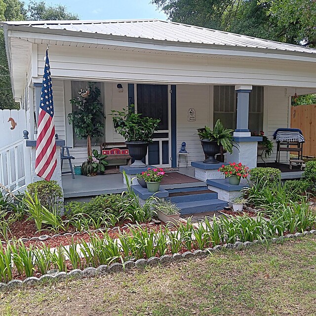 72 Park Ave, Defuniak Springs, FL 32435 - back of house featuring a porch and metal roof