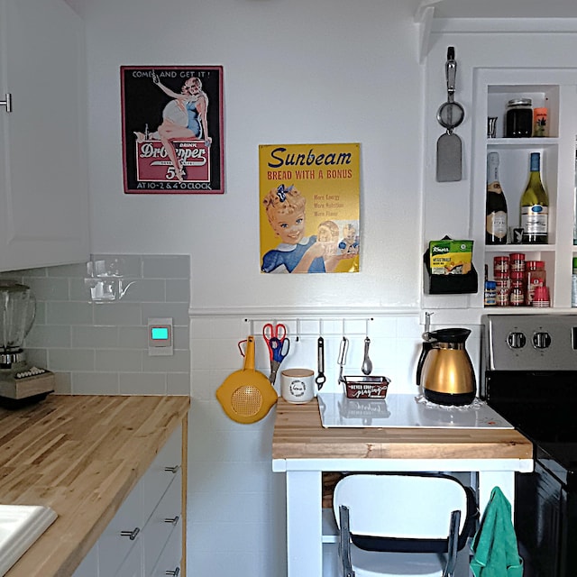 72 Park Ave, Defuniak Springs, FL 32435 - detailed view of white cabinetry, light countertops, decorative backsplash, and electric range oven