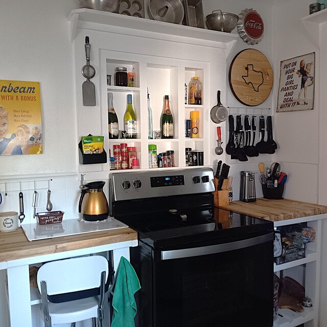 72 Park Ave, Defuniak Springs, FL 32435 - detailed view of electric range, a bar, and decorative backsplash
