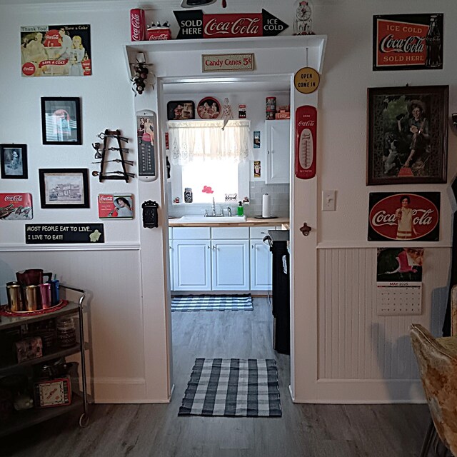 72 Park Ave, Defuniak Springs, FL 32435 - kitchen featuring dark wood-style floors, white cabinetry, light countertops, and a sink