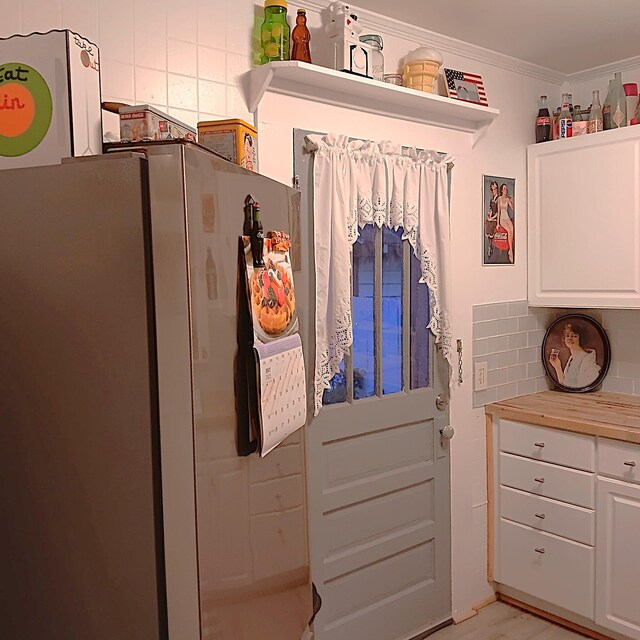 72 Park Ave, Defuniak Springs, FL 32435 - kitchen featuring white cabinetry, ornamental molding, and tasteful backsplash