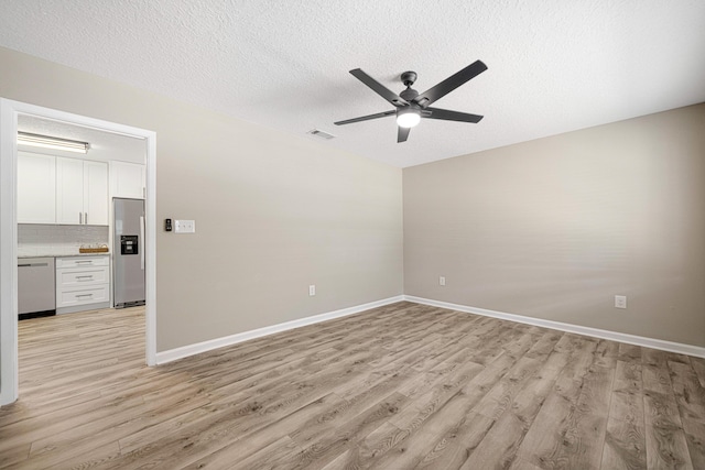 207 Oglesby Ave, Crestview, FL 32536 - empty room with ceiling fan, light wood-type flooring, and a textured ceiling