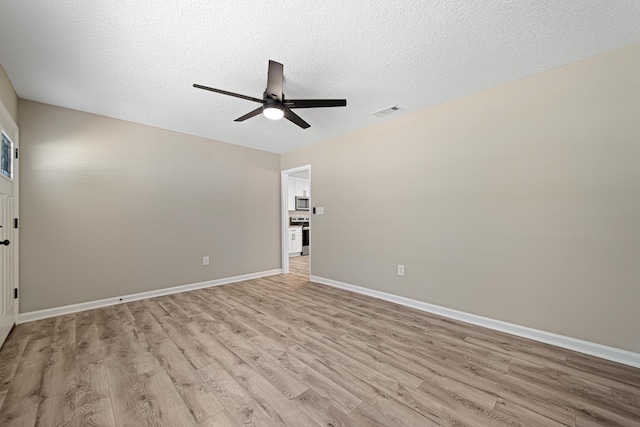 207 Oglesby Ave, Crestview, FL 32536 - empty room with ceiling fan, light wood-style floors, and a textured ceiling